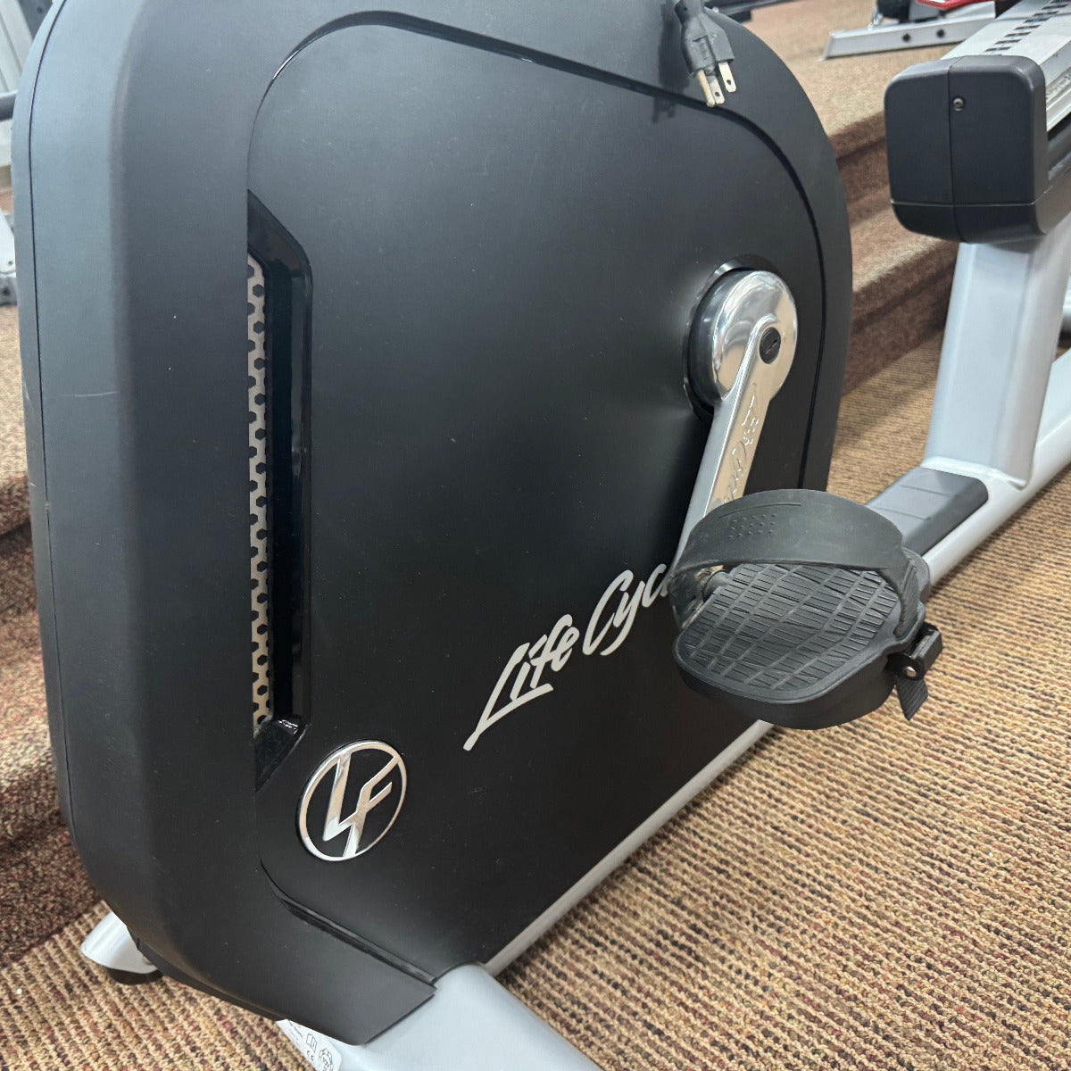Close-up of a Life Fitness exercise bike on a carpeted floor