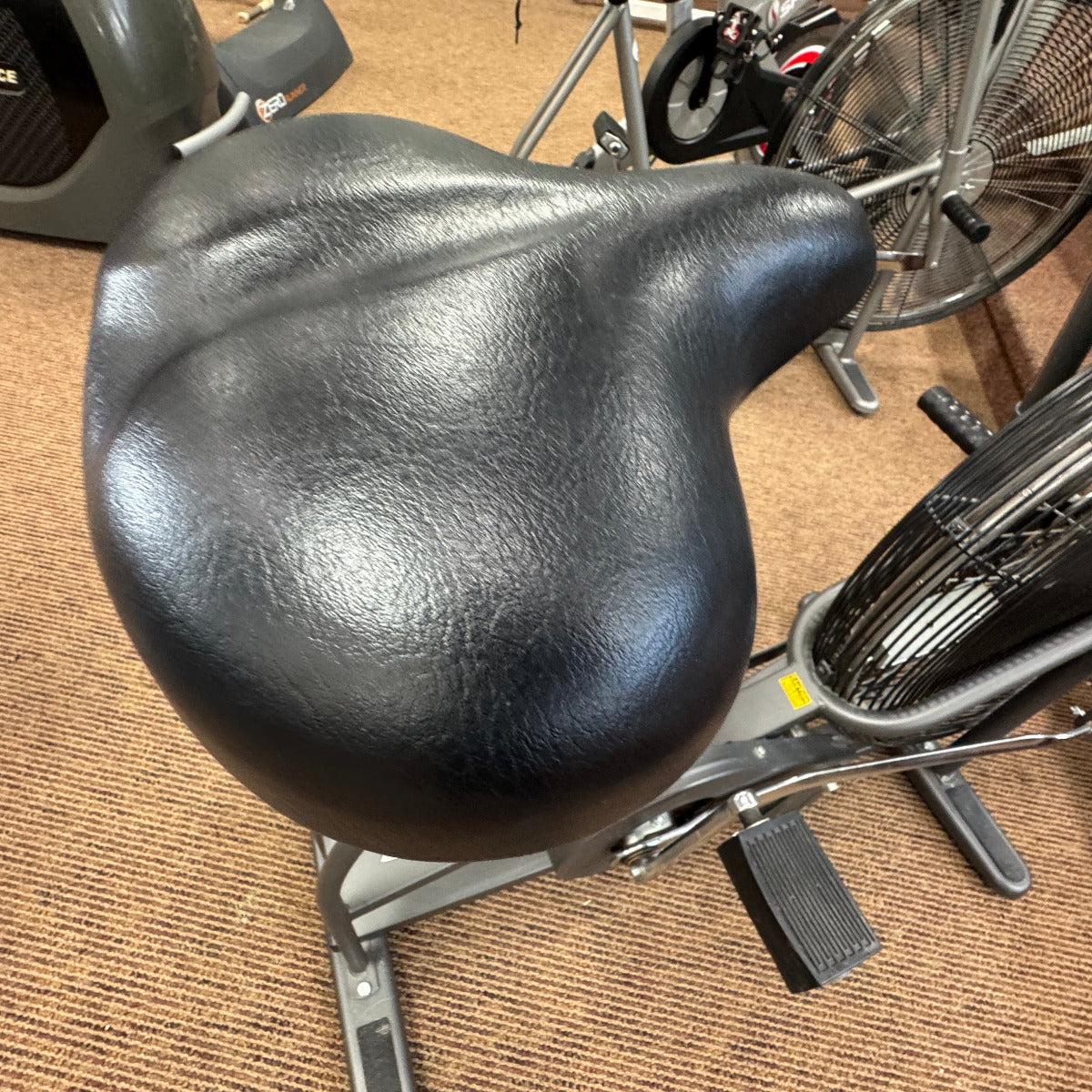 Black seat on a stationary bike
