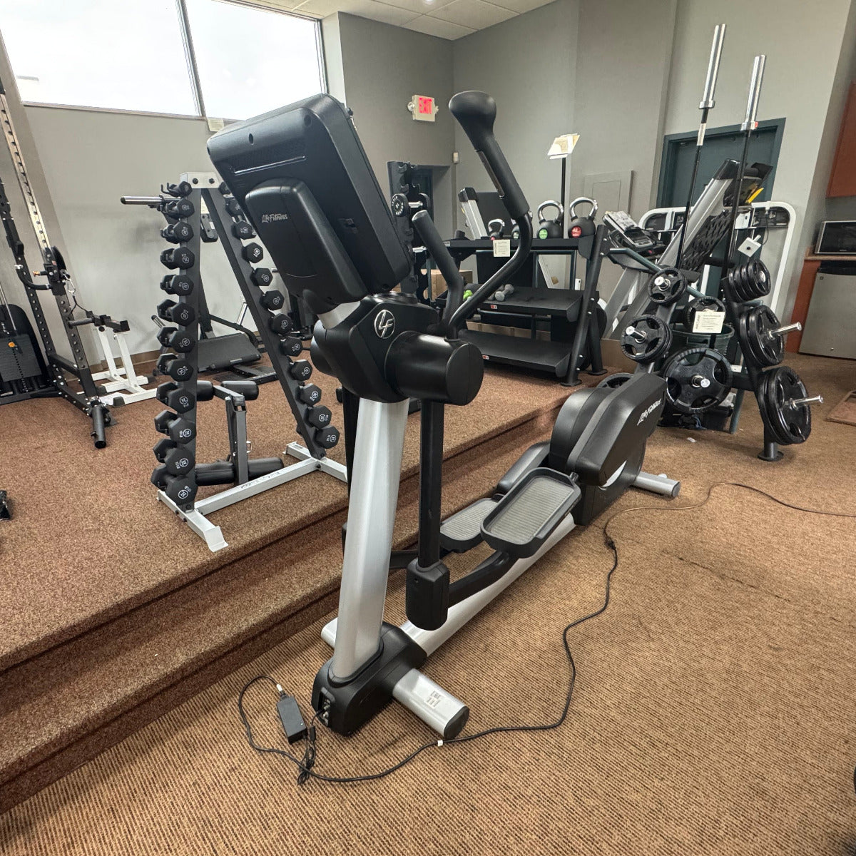 Gym interior with exercise equipment on a wooden floor