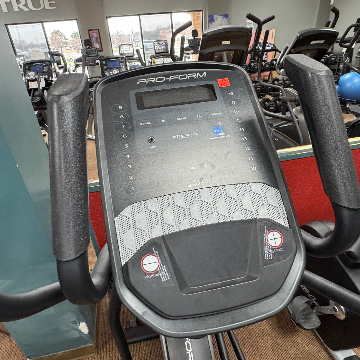 Close-up of a ProForm elliptical machine console in a gym setting